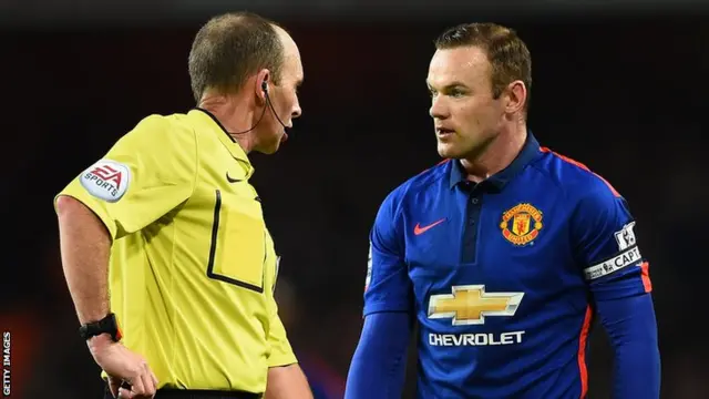 Manchester United captain Wayne Rooney speaks to referee Mike Dean