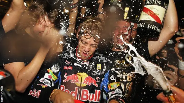 Race winner and F1 2010 World Champion Sebastian Vettel of Germany and Red Bull Racing celebrates with team mates