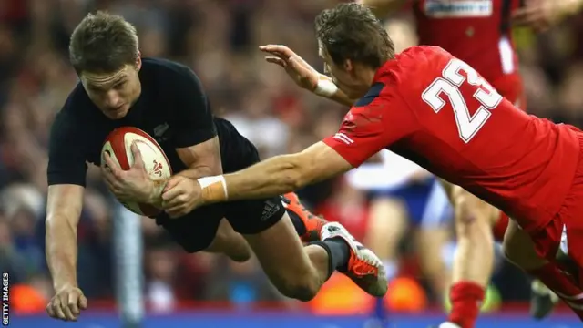 New Zealand fly-half Beauden Barrett scores the first of his two tries against Wales