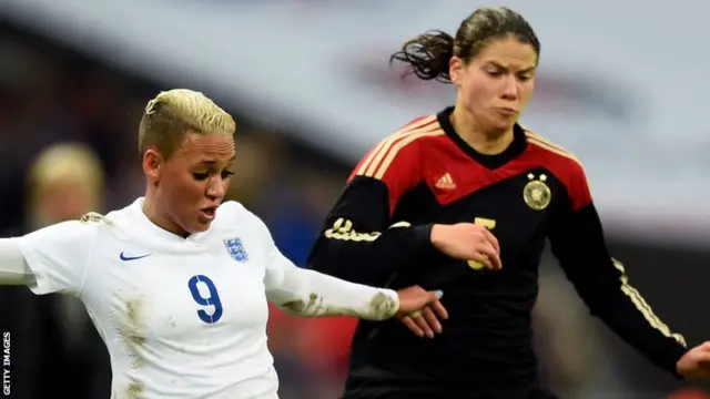 Annike Krahn of Germany is tackled by Lianne Sanderson