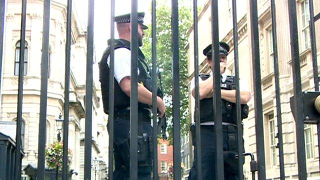 Police officers behind gate