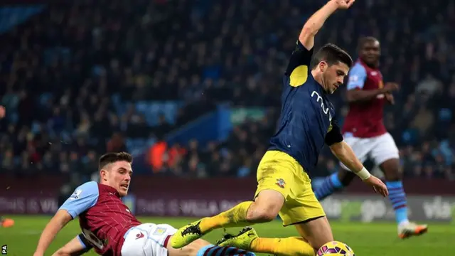 Shane Long is challenged by Ciarran Clark