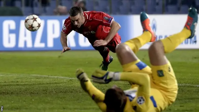 Liverpool striker Rickie Lambert misses with a header