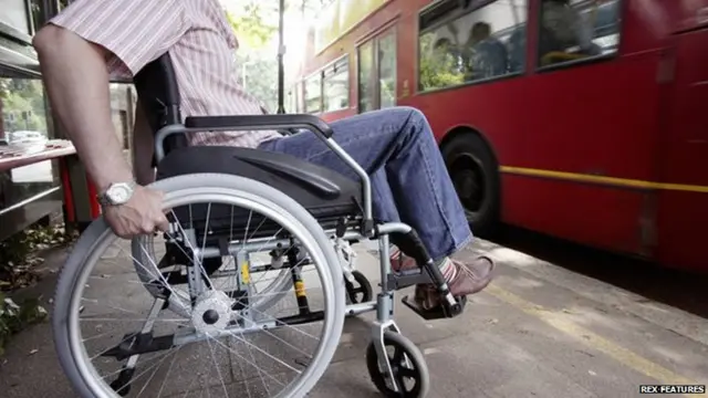 Man in wheelchair waiting for bus