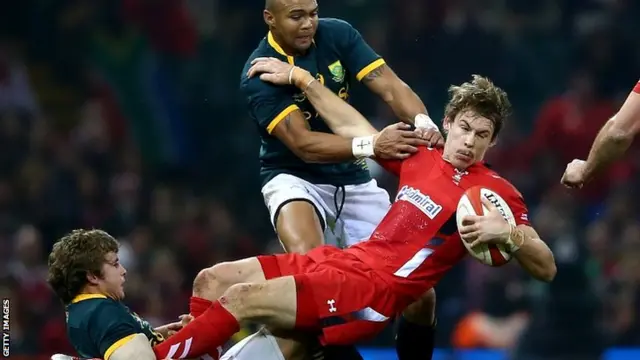 Liam Williams of Wales holds onto the ball against Pat Lambie (L) and Cornal Hendricks (C) of South Africa