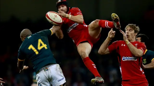 Wales Leigh Halfpenny is tackled by South Africa's Cornal Hendricks