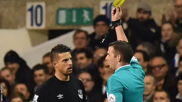 Kevin Mirallas receives a yellow card