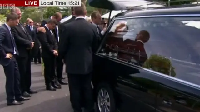 Phillip Hughes casket is placed in a hearse