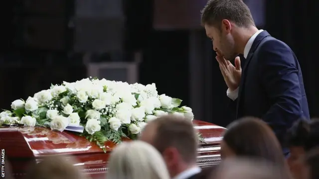 Michael Clarke blows a kiss to Phillip Hughes's casket