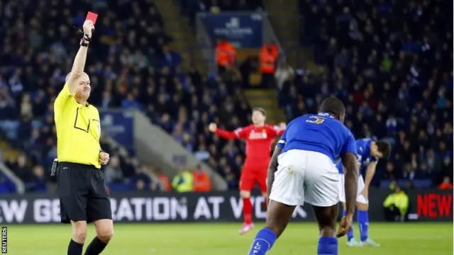 Lee Mason shows a red card to Wes Morgan