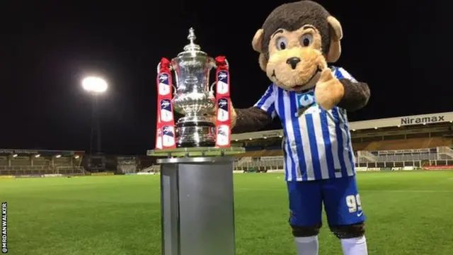 Hangus the monkey with the FA Cup