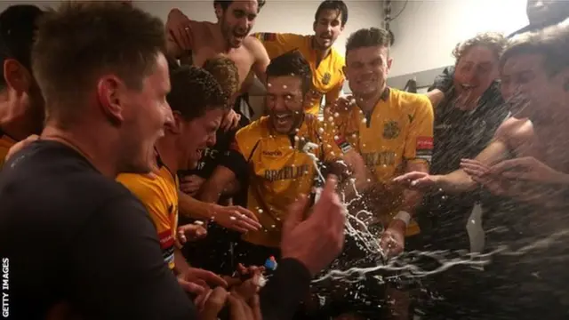 Maidstone United players celebrate in the changing room after the game