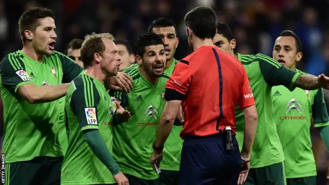 Celta Vigo players protest the awarding of a penalty for Real Madrid