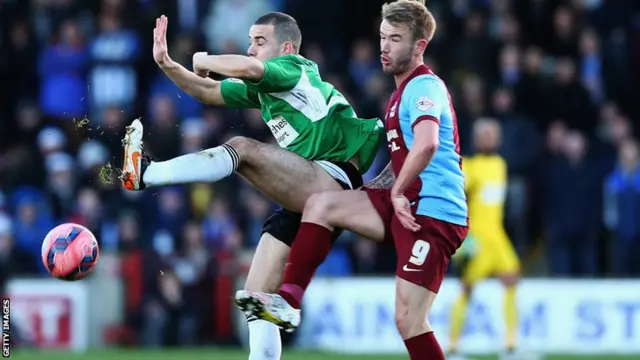 Tyler Weir of Worcester City and Paddy Madden of Scunthorpe United