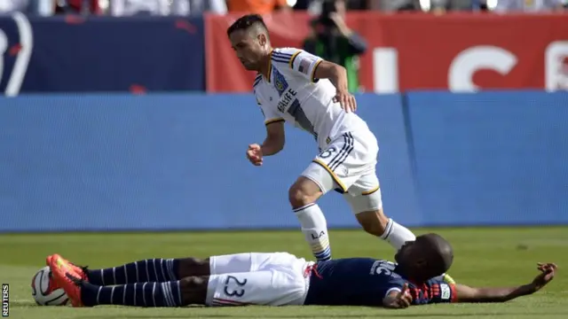 New England Revolution defender Jose Goncalves is fouled by Los Angeles Galaxy midfielder Marcelo Sarvas