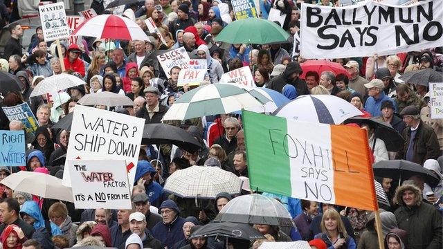 Protesters hold signs and flags