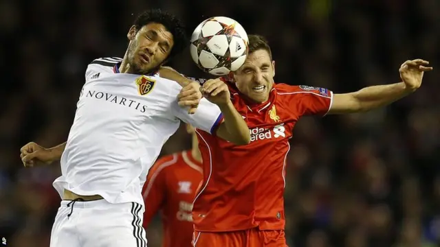 Liverpool's Joe Allen goes up for the ball against Basel