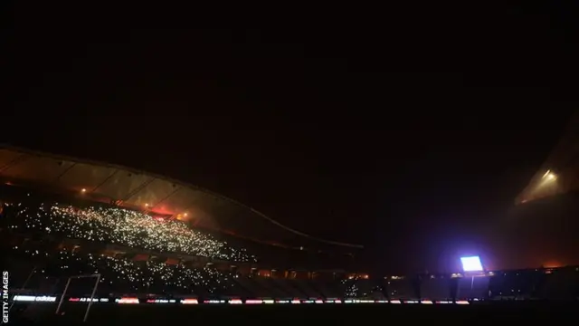 Istanbul's Olympic Stadium is covered in darkness as the lights go out