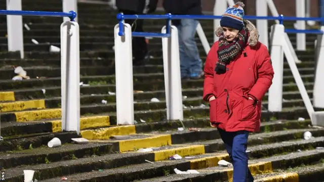 A Rangers fan trudges away from Palmerston