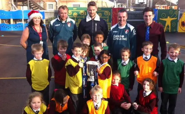 Simon Francis with pupils and League Cup