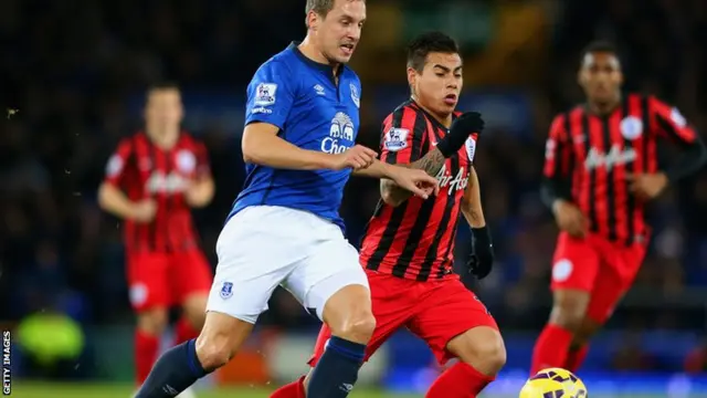 Jagielka and Vargas battle for the ball