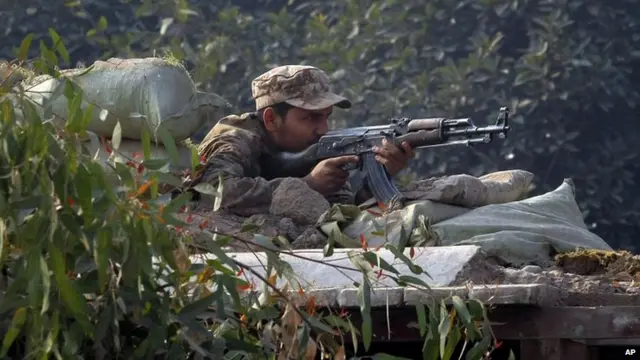 A Pakistani army soldier takes position on a bunker close to a school under attack by Taliban gunmen in Peshawar, Pakistan, 16 December 2014.