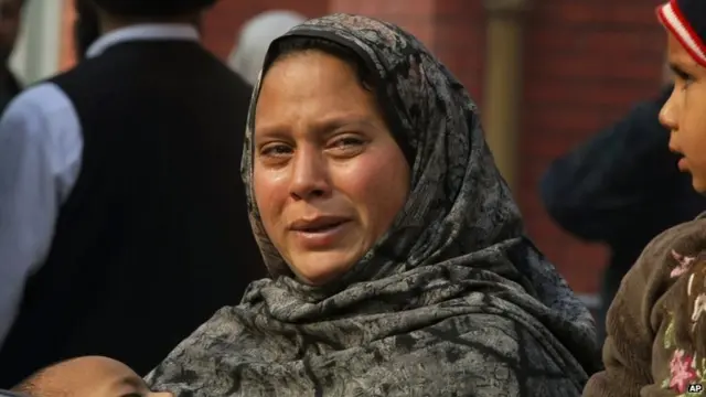 A Pakistani woman weeps as she waits at a hospital, where victims of a Taliban attack are being treated in Peshawar, Pakistan,Tuesday, Dec. 16, 2014