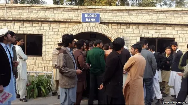 People gather outside the blood bank