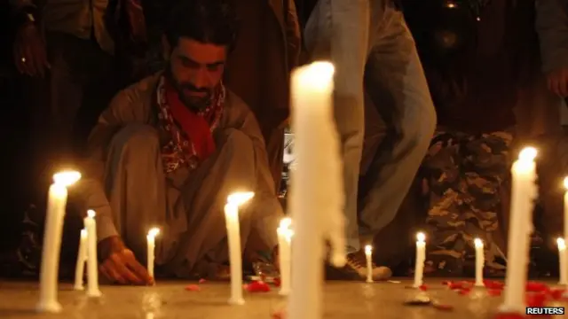 A man lights candles to mourn the Peshawar victims in Karachi, southern Pakistan