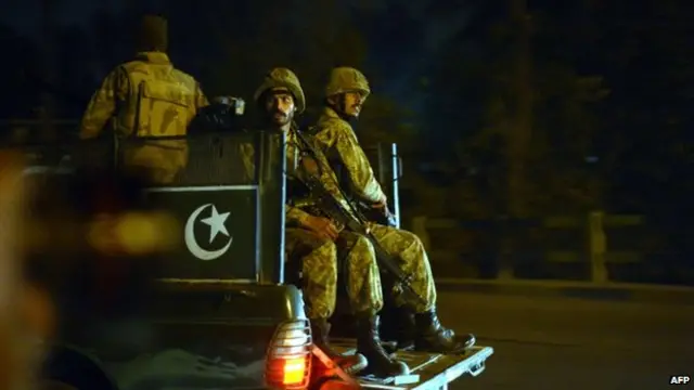 Pakistani soldiers patrol the streets of Peshawar