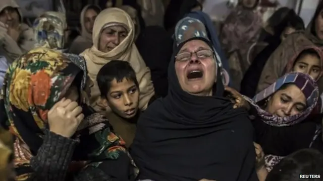 Women mourn their relative Mohammed Ali Khan, 15, a student who was killed during the attack