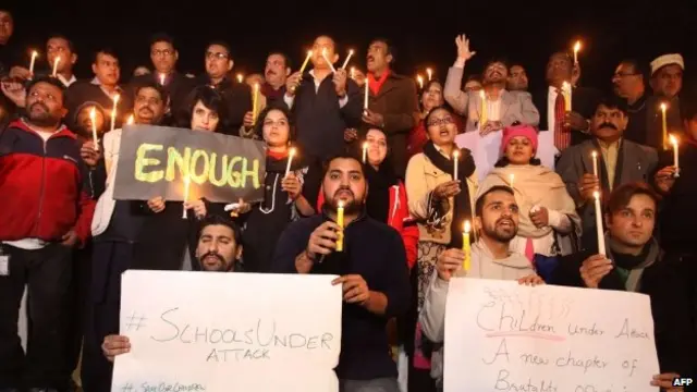 Members of Pakistan's civil society and journalists light candles for the Peshawar victims in Islamabad