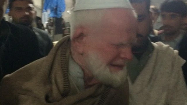 A man cries after learning that his brother was killed