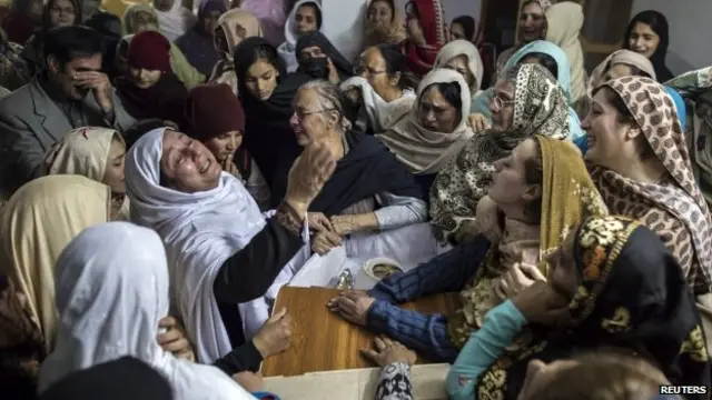 Women mourn their relative Mohammed Ali Khan, 15, a student who was killed during an attack by Taliban gunmen on the Army Public School