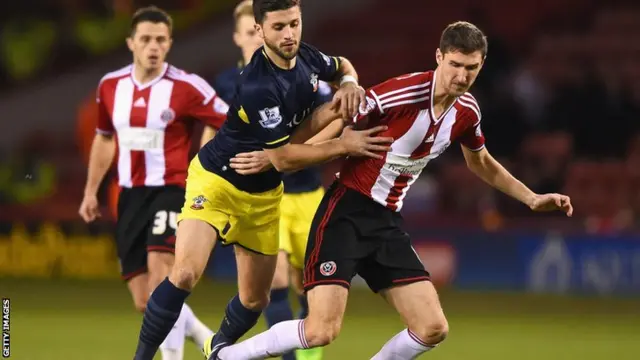 Shane Long Southampton and Chris Basham Shef Utd