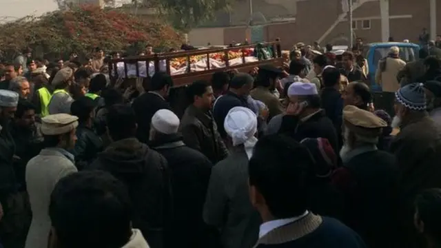 Coffin being carried through the streets