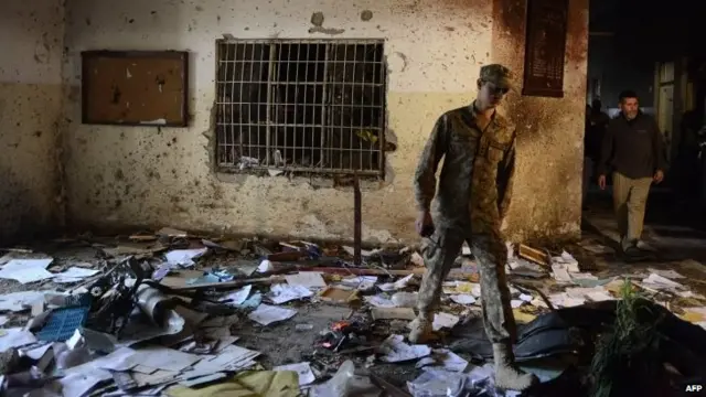 A Pakistani soldier walks amidst the debris at the army-run school in Peshawar - 17 December 2014