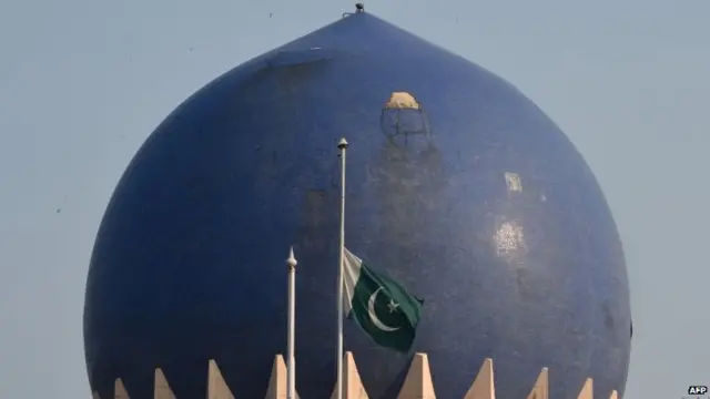 A Pakistani flag flies at half-mast at the country's embassy in Delhi, India