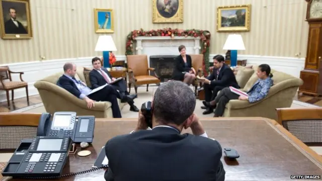 US President Barack Obama talks with President Raul Castro of Cuba from the Oval Office in Washington DC on 16 December 2014