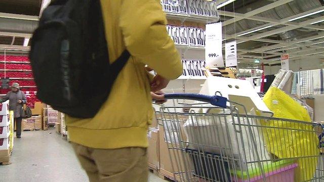 Shopper with trolley full of goods