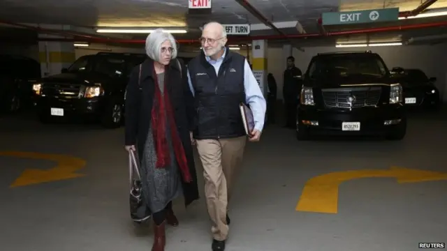 Alan and Judy Gross walk through a parking garage after arriving for a news conference in Washington December 17, 2014.