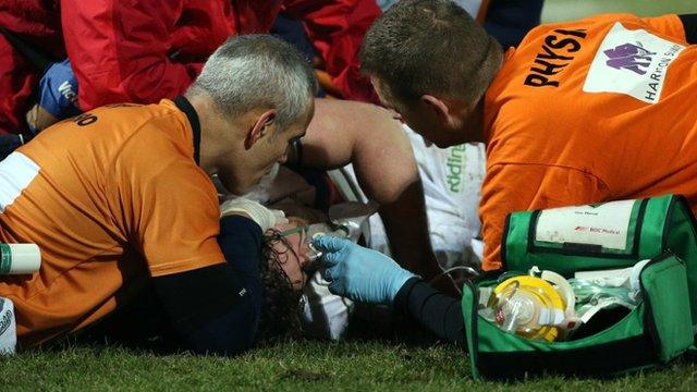 Kyle Amor receives treatment for a head injury