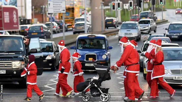 Runners make their way to the start of a 'Santa dash'