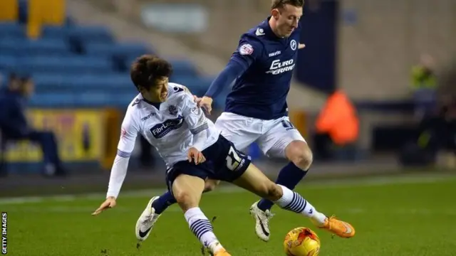 Bolton and Millwall players battle for the ball