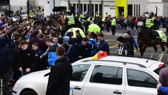 Police control the fans outside St James' Park