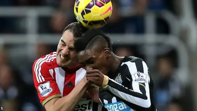 Sammy Ameobi goes for a header with John O'Shea