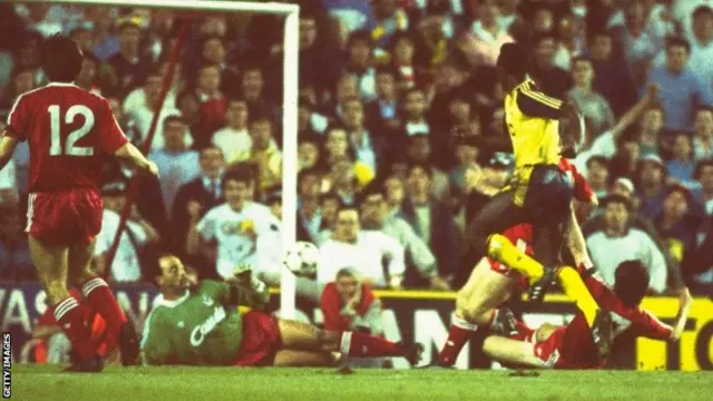 Michael Thomas of Arsenal scores at Anfield in 1989