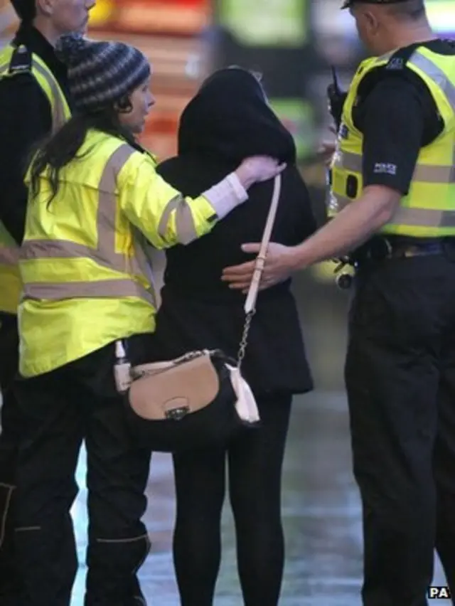 A member of the public is comforted by emergency services close to the scene in Glasgow"s George Square