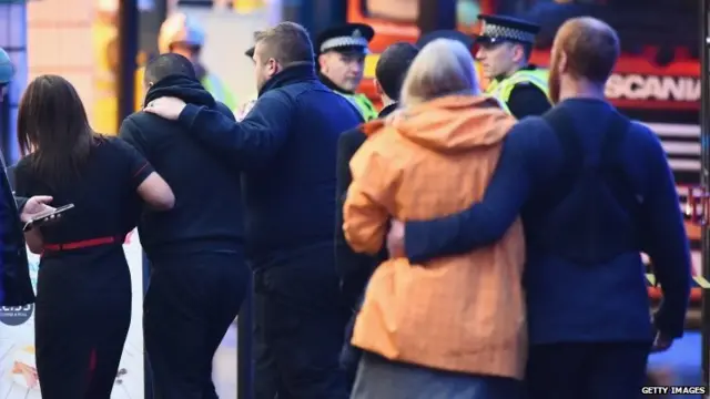 Members of the public comfort each other after the incident in George Square