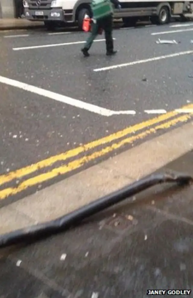 Metal poles bent over by bin lorry